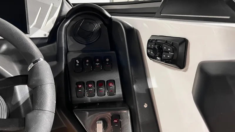 Slide: The Image of 2024 Supreme S220 boat dashboard with control panel and steering wheel. - 27