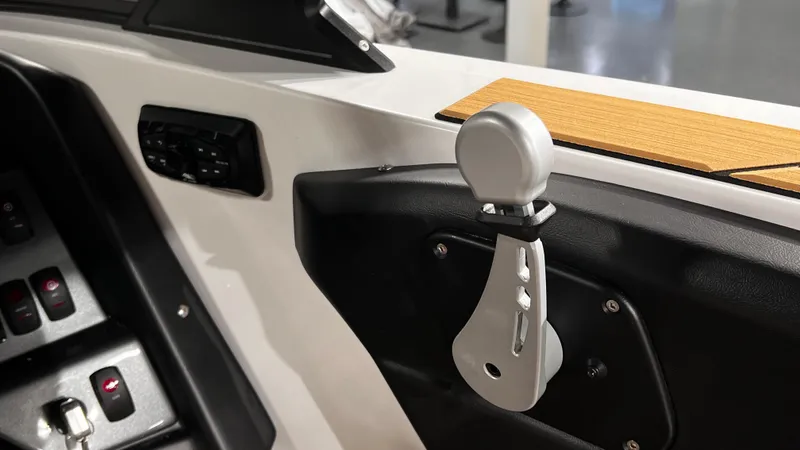 Slide: The Image of 2024 Supreme S220 boat interior with control panel and handle. - 29