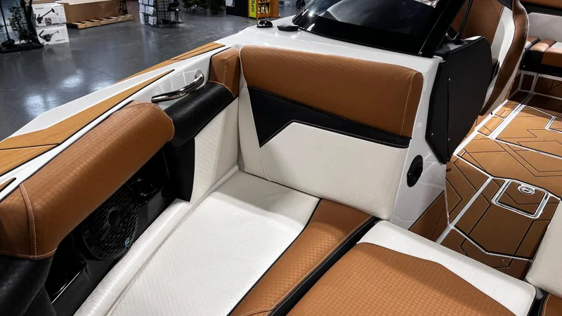 Slide: The Image of 2024 Supreme S220 boat interior with brown and white leather seating. - 32