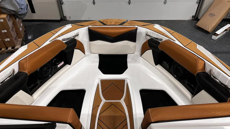 Slide: The Image of 2024 Supreme S220 boat interior with brown and white seating. - 36
