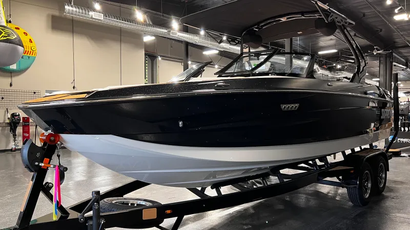 Slide: The Image of 2024 Supreme S220 boat on trailer in showroom. - 4