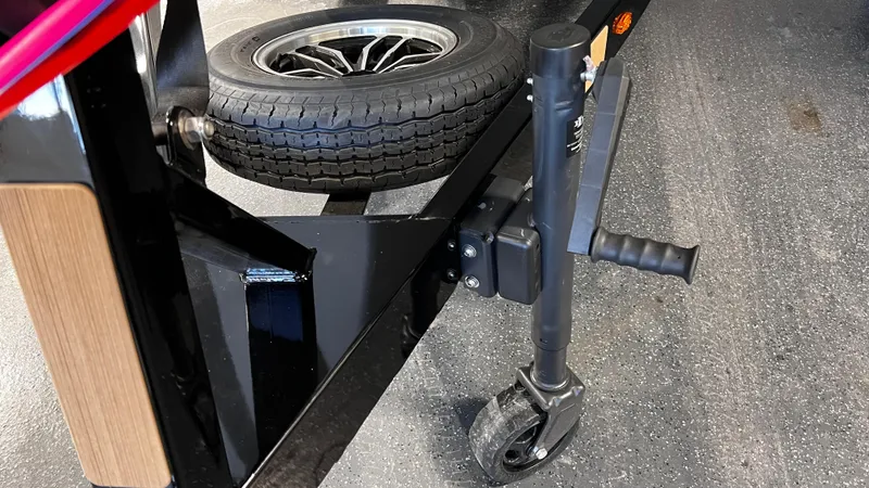 Slide: The Image of 2024 Supreme S220 trailer with spare tire and jack on asphalt. - 5