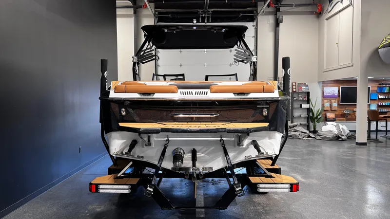 Slide: The Image of 2024 Supreme S220 boat in showroom, rear view, modern design. - 9