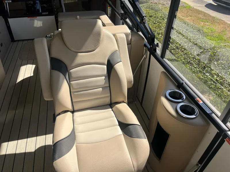 Slide: The Image of 2024 G3 322SS boat interior with beige seating and cup holders. - 12