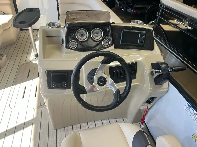 Slide: The Image of 2024 G3 322SS boat dashboard with steering wheel and control panel. - 14