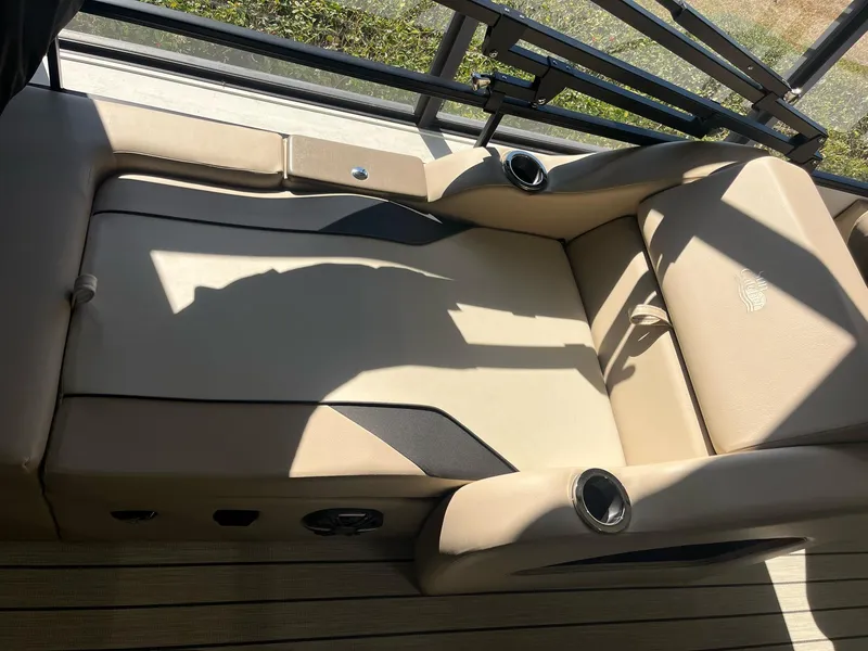 Slide: The Image of 2024 G3 322SS boat interior with beige seating and cup holders. - 15