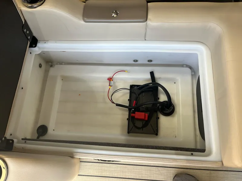 Slide: The Image of 2024 G3 322SS boat storage compartment with battery and wiring. - 18