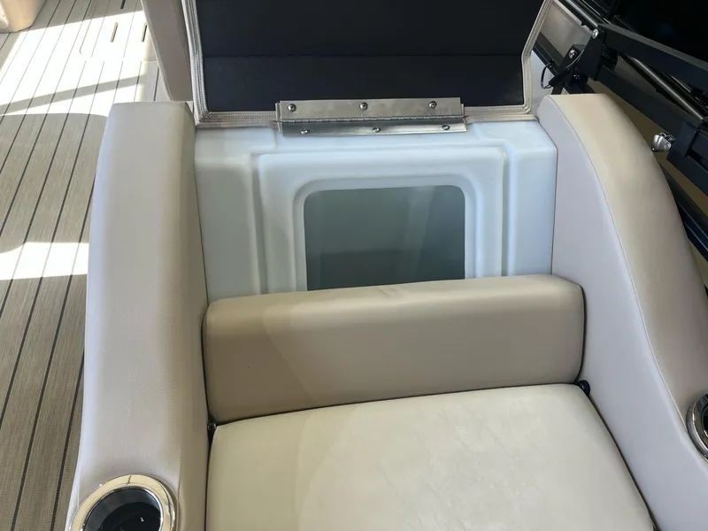 Slide: The Image of 2024 G3 322SS boat seat with storage compartment, beige upholstery, and cup holders. - 19