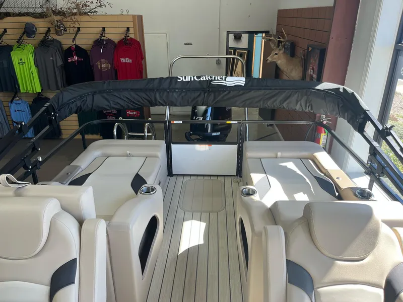 Slide: The Image of 2024 G3 322SS pontoon boat interior with seating and canopy in showroom. - 24