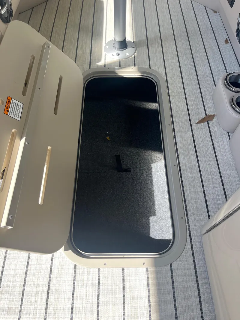 Slide: The Image of Open storage compartment on 2024 G3 322SS boat deck. - 25