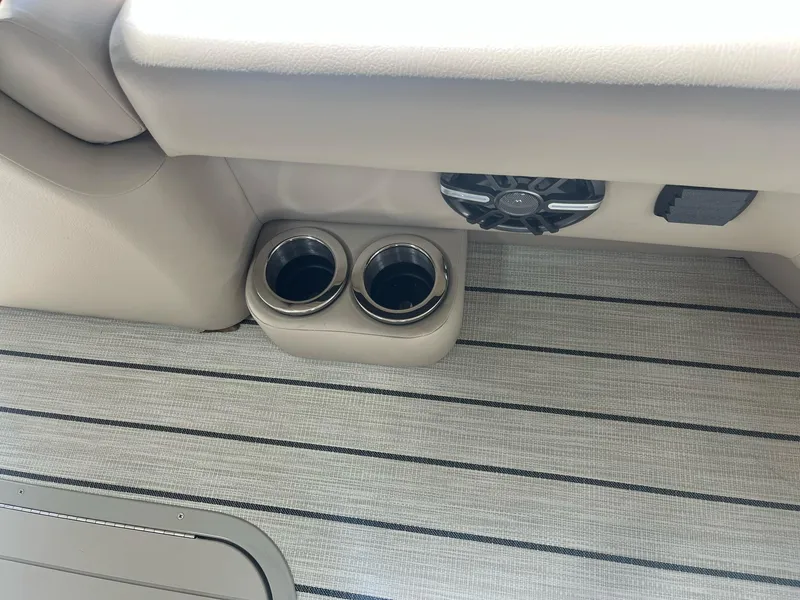Slide: The Image of 2024 G3 322SS boat interior with cup holders and speaker on striped flooring. - 8