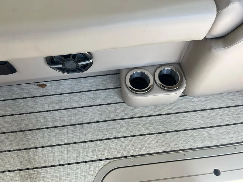 Slide: The Image of 2024 G3 322SS boat interior with cup holders and speaker on striped flooring. - 9