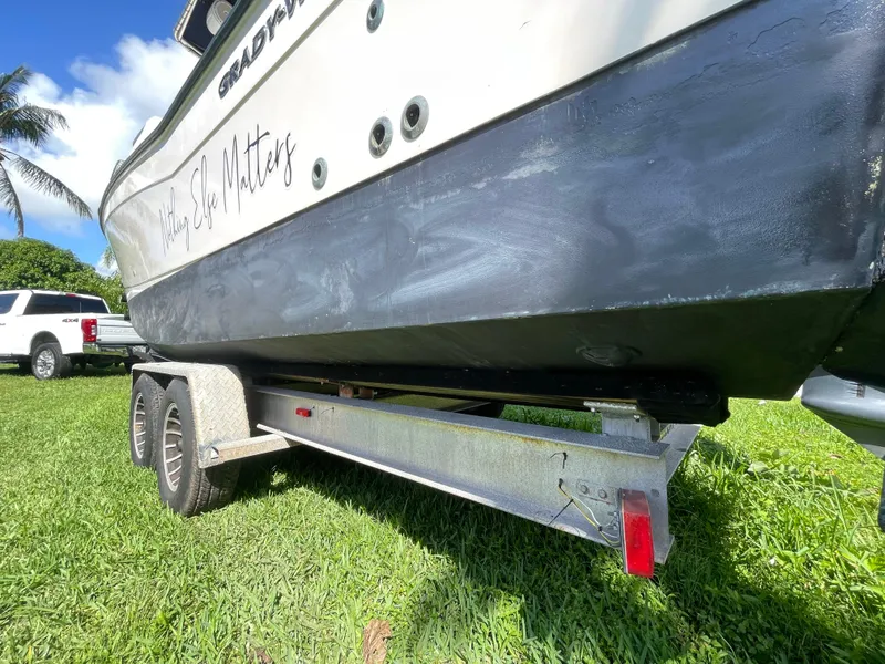 Slide: The Image of 1999 Grady-White X-26 Tiger Cat boat on trailer, parked on grass. - 16