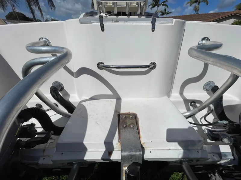 Slide: The Image of 1999 Grady-White X-26 Tiger Cat boat interior with metal railings and white seating area. - 17