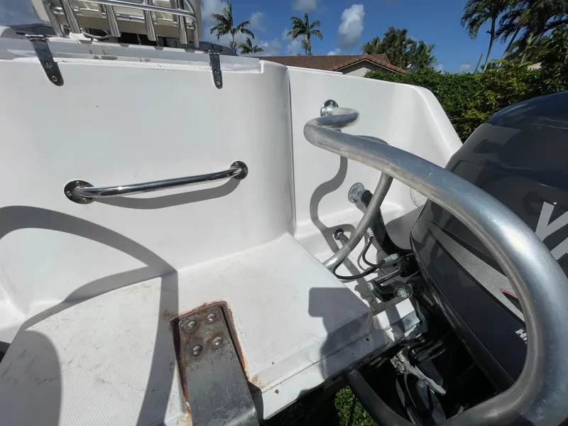 Slide: The Image of 1999 Grady-White X-26 Tiger Cat boat stern with railing and motor, sunny day. - 18