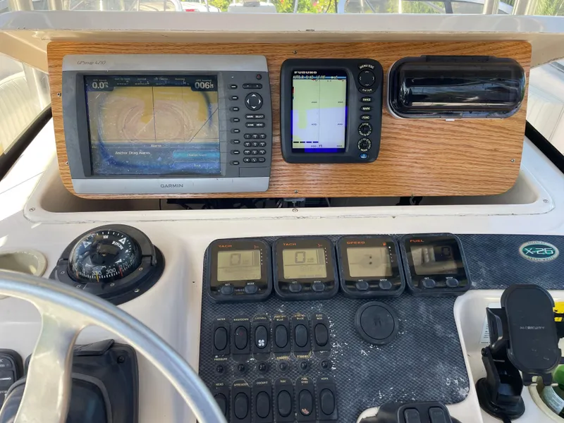 Slide: The Image of Dashboard of 1999 Grady-White X-26 Tiger Cat with navigation instruments and controls. - 23
