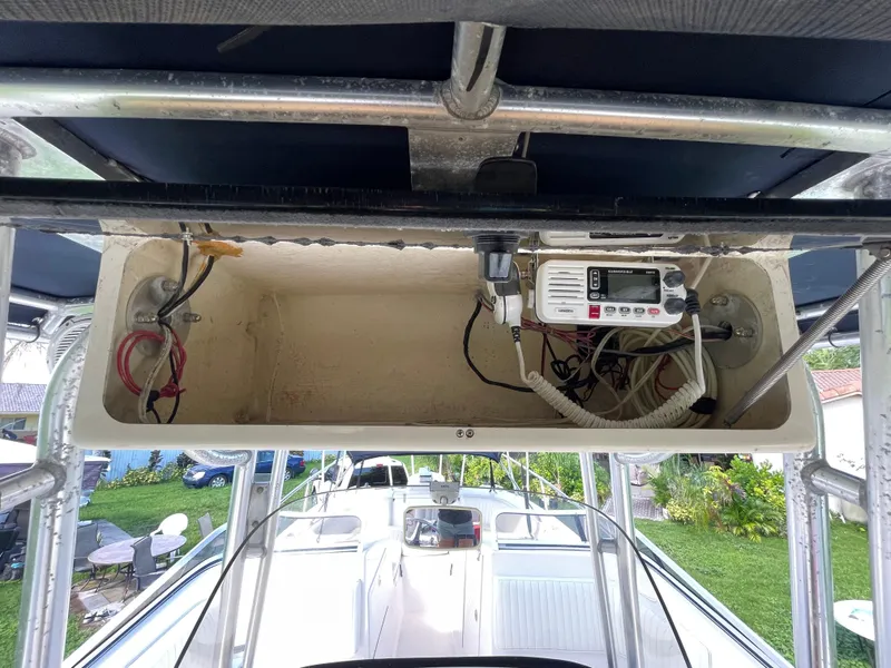 Slide: The Image of 1999 Grady-White X-26 Tiger Cat boat electronics compartment with wiring and radio equipment. - 27