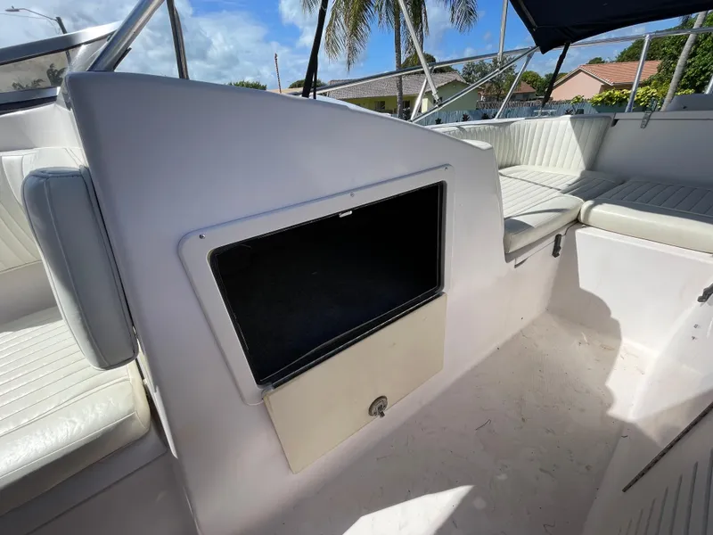 Slide: The Image of 1999 Grady-White X-26 Tiger Cat boat interior with seating and storage compartment. - 33