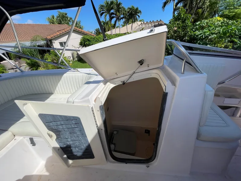 Slide: The Image of 1999 Grady-White X-26 Tiger Cat boat interior with open storage compartment. - 35