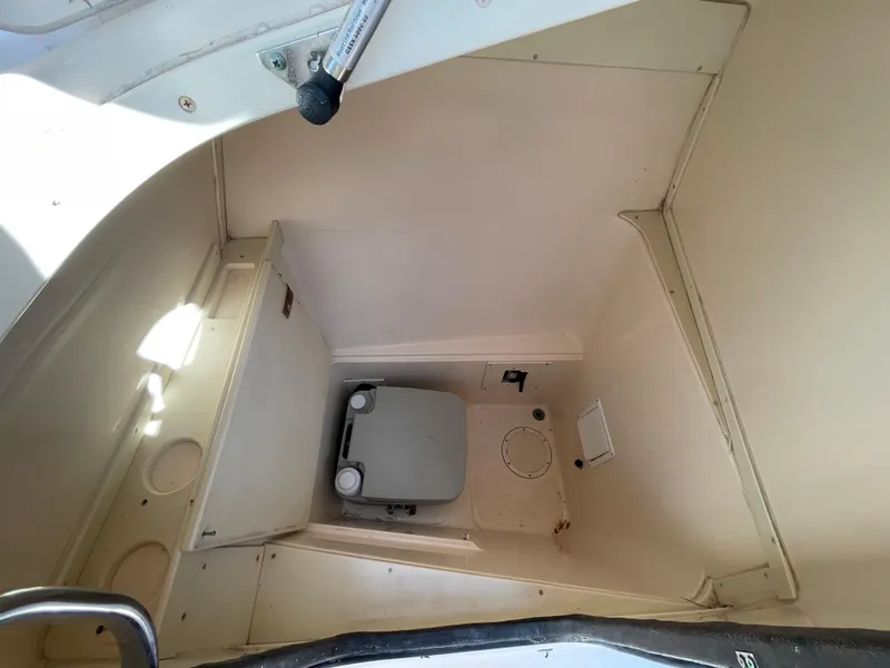Slide: The Image of 1999 Grady-White X-26 Tiger Cat boat interior with compact toilet. - 36