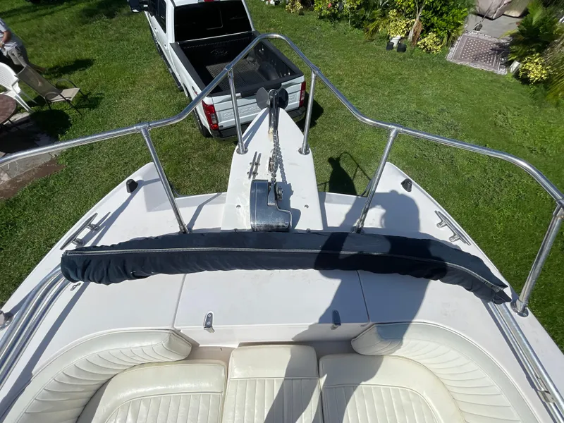 Slide: The Image of 1999 Grady-White X-26 Tiger Cat boat deck with railing and anchor, parked on grass. - 40