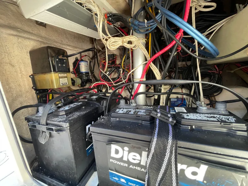 Slide: The Image of 1999 Grady-White X-26 Tiger Cat boat battery compartment with DieHard batteries and wiring. - 46
