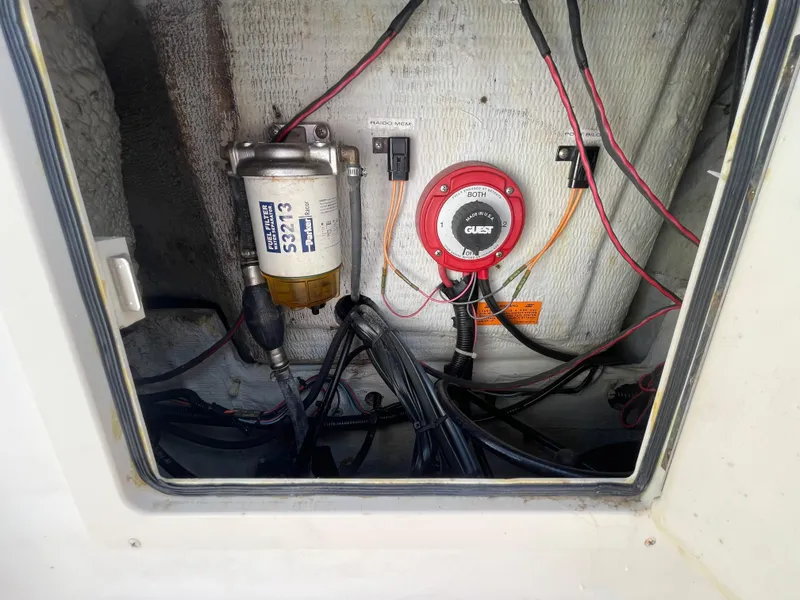 Slide: The Image of 1999 Grady-White X-26 Tiger Cat engine compartment with wiring and fuel filter. - 51