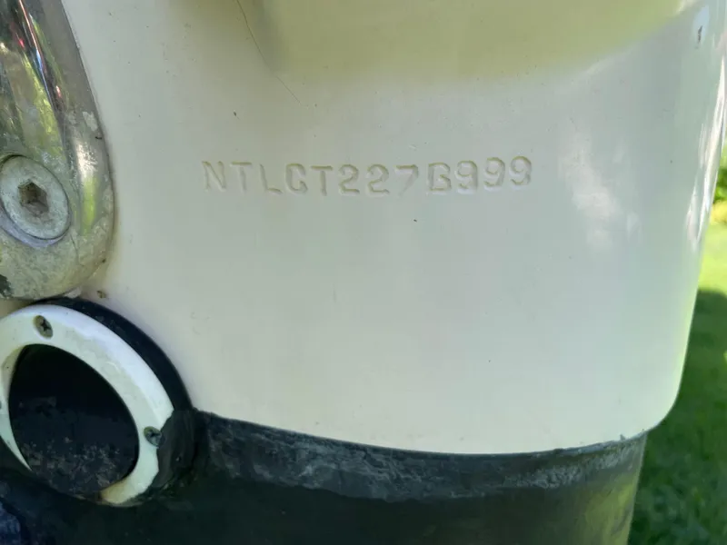 Slide: The Image of Close-up of a 1999 Grady-White X-26 Tiger Cat hull identification number. - 54