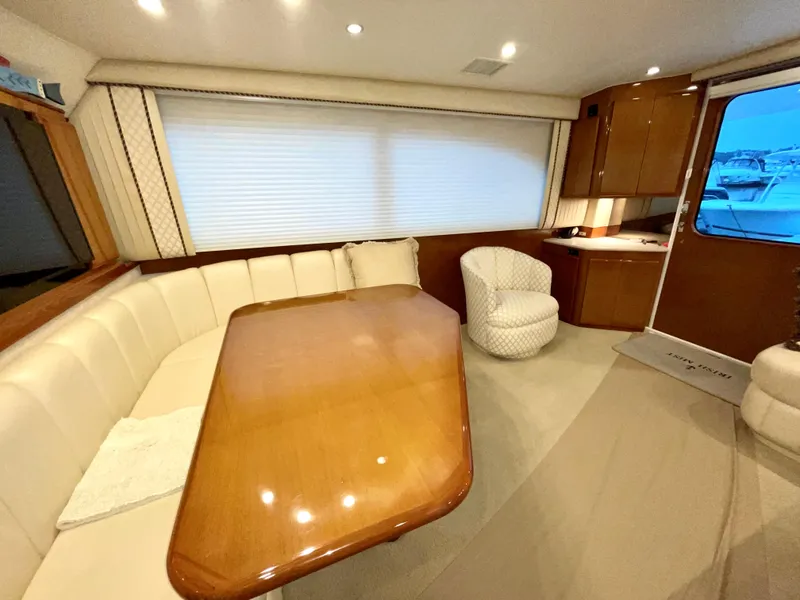 Slide: The Image of Interior of 2001 Post 50 Convertible yacht with dining area and plush seating. - 13