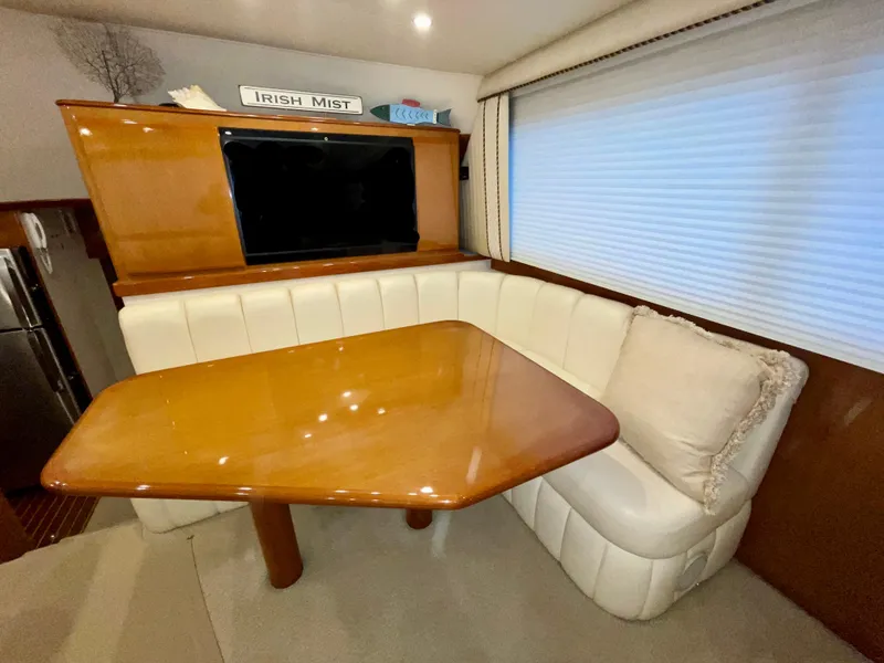Slide: The Image of Luxurious interior of a 2001 Post 50 Convertible yacht with a cozy dining area. - 14