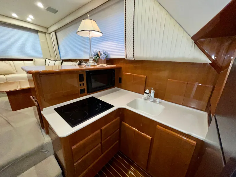 Slide: The Image of Luxurious kitchen area in a 2001 Post 50 Convertible yacht with modern amenities. - 20