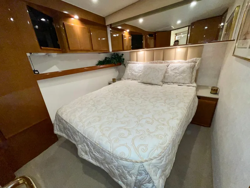 Slide: The Image of Luxurious bedroom interior of a 2001 Post 50 Convertible yacht with elegant bedding. - 22