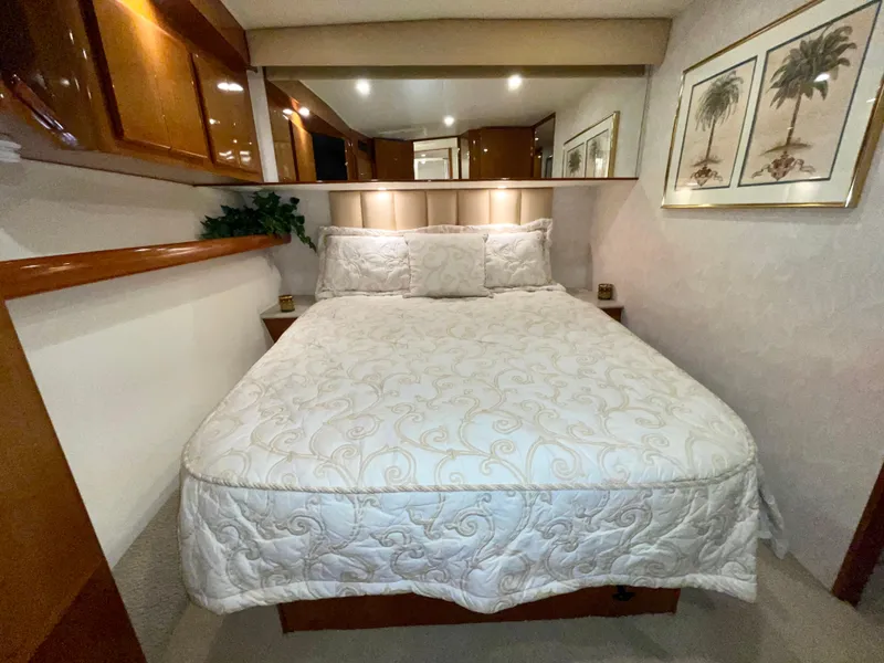 Slide: The Image of Luxurious bedroom interior of a 2001 Post 50 Convertible yacht with elegant bedding and decor. - 23