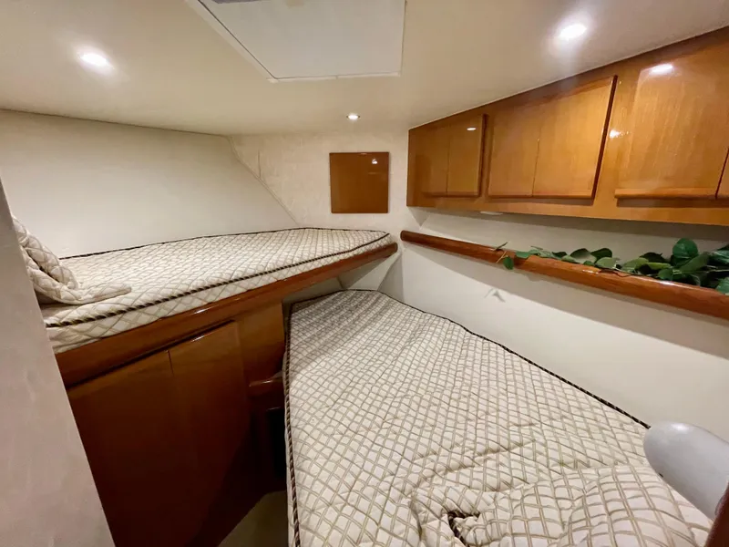 Slide: The Image of Interior cabin of 2001 Post 50 Convertible yacht with twin beds and wooden cabinets. - 29