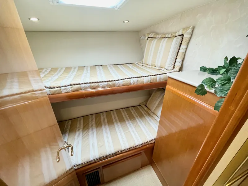 Slide: The Image of Interior of 2001 Post 50 Convertible yacht with bunk beds and wooden cabinetry. - 31