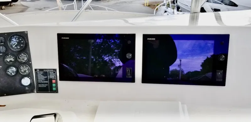 Slide: The Image of Boat dashboard with dual screens and gauges, Post 50 Convertible, 2001 model. - 35