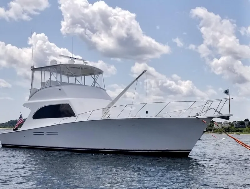 Slide: The Image of 2001 Post 50 Convertible yacht on water under cloudy sky. - 40
