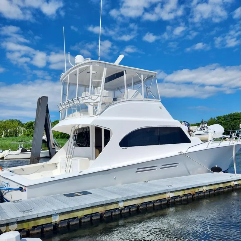 Slide: The Image of 2001 Post 50 Convertible yacht docked under a clear blue sky. - 41