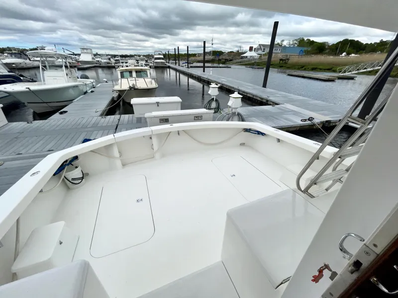 Slide: The Image of 2001 Post 50 Convertible yacht docked at marina, spacious deck, overcast sky. - 42