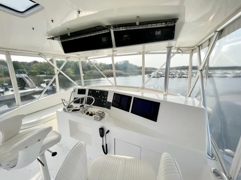 Slide: The Image of 2001 Post 50 Convertible yacht helm with modern navigation equipment and panoramic water views. - 47