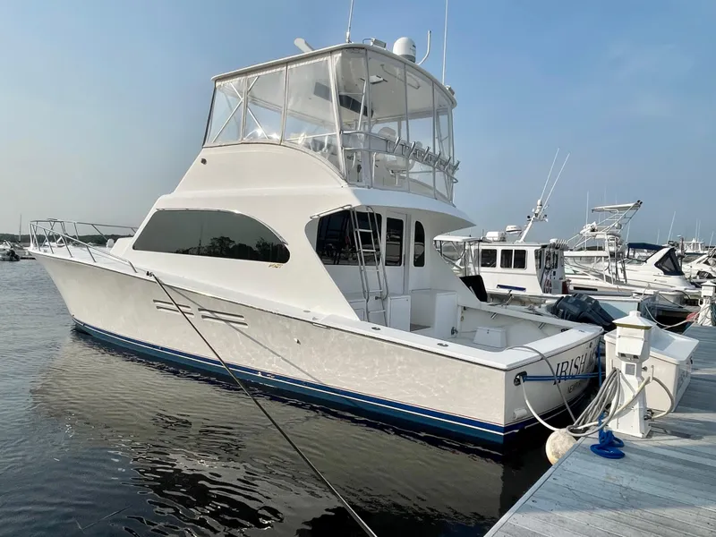 Slide: The Image of 2001 Post 50 Convertible yacht docked at marina, featuring sleek design and spacious deck. - 49