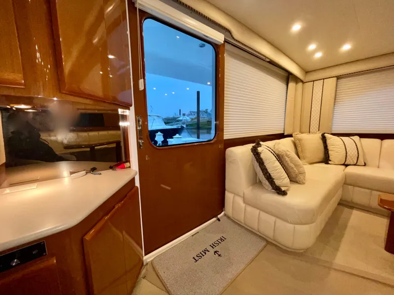Slide: The Image of Luxurious interior of a 2001 Post 50 Convertible yacht with plush seating and elegant wood finishes. - 9
