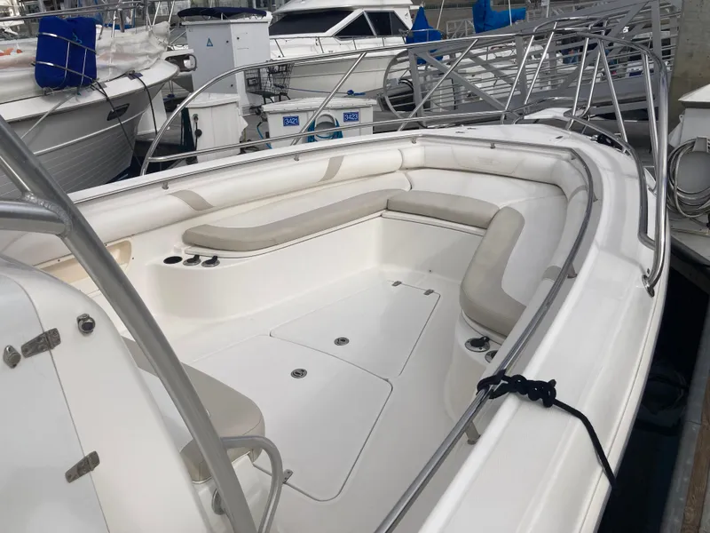 Slide: The Image of 2007 Boston Whaler 320 Outrage boat with spacious seating area docked at marina. - 20