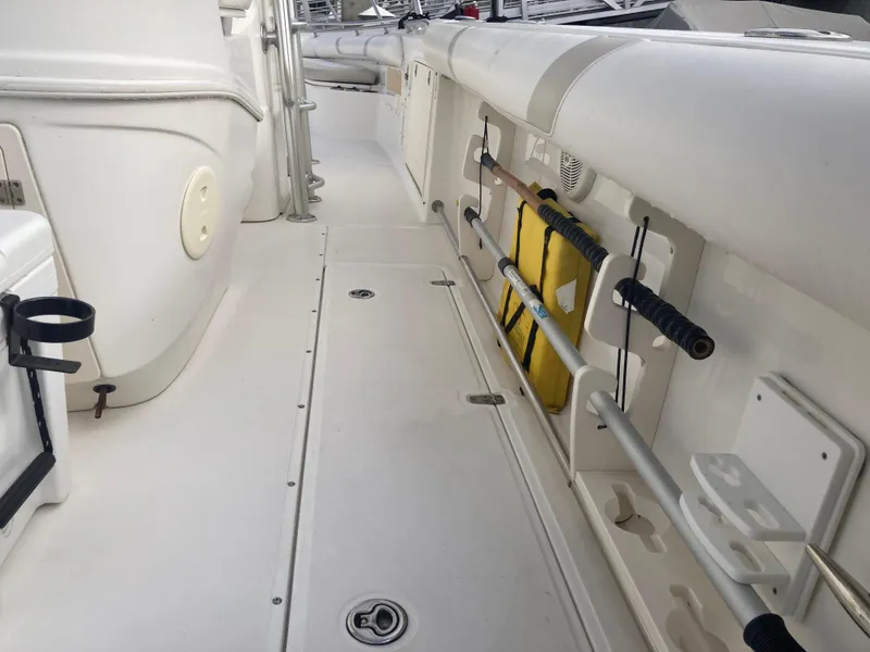 Slide: The Image of 2007 Boston Whaler 320 Outrage deck with rod holders and storage compartments. - 27