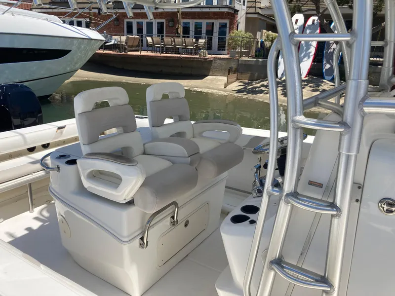 Slide: The Image of 2007 Boston Whaler 320 Outrage boat interior with cushioned seating and stainless steel fixtures. - 32