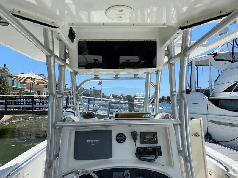 Slide: The Image of 2007 Boston Whaler 320 Outrage boat console with navigation equipment and marina view. - 34