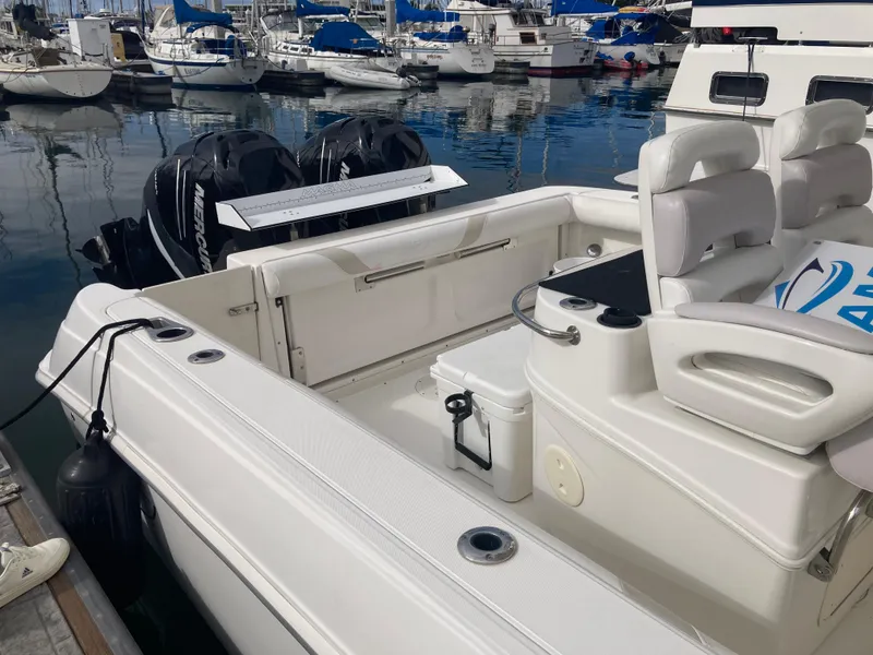 Slide: The Image of 2007 Boston Whaler 320 Outrage boat docked, featuring dual engines and spacious seating. - 37