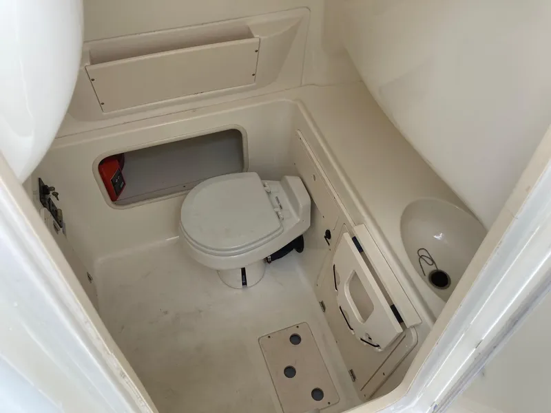 Slide: The Image of 2007 Boston Whaler 320 Outrage boat interior bathroom with toilet and sink. - 47