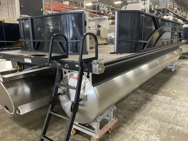Slide: The Image of 2025 Bennington 23 SL pontoon boat in a warehouse setting. - 11