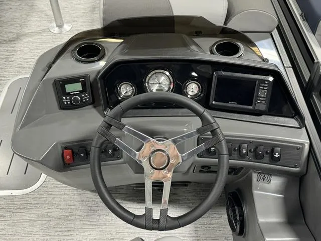 Slide: The Image of 2025 Bennington 23 SSB pontoon boat interior with gray seating and branding. - 10